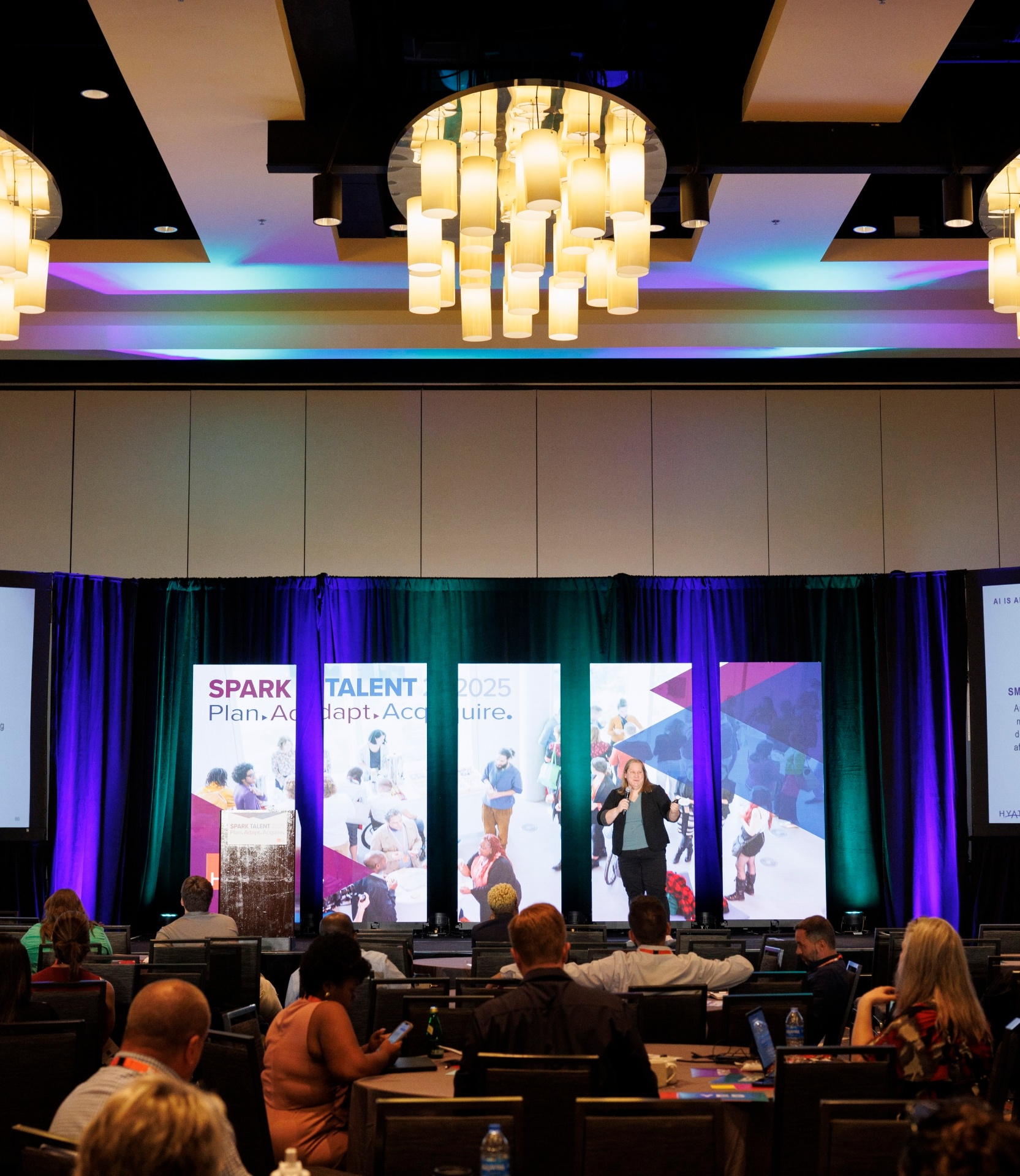 Carlee Wolfe on stage at HCI's Spark Conference 2025.